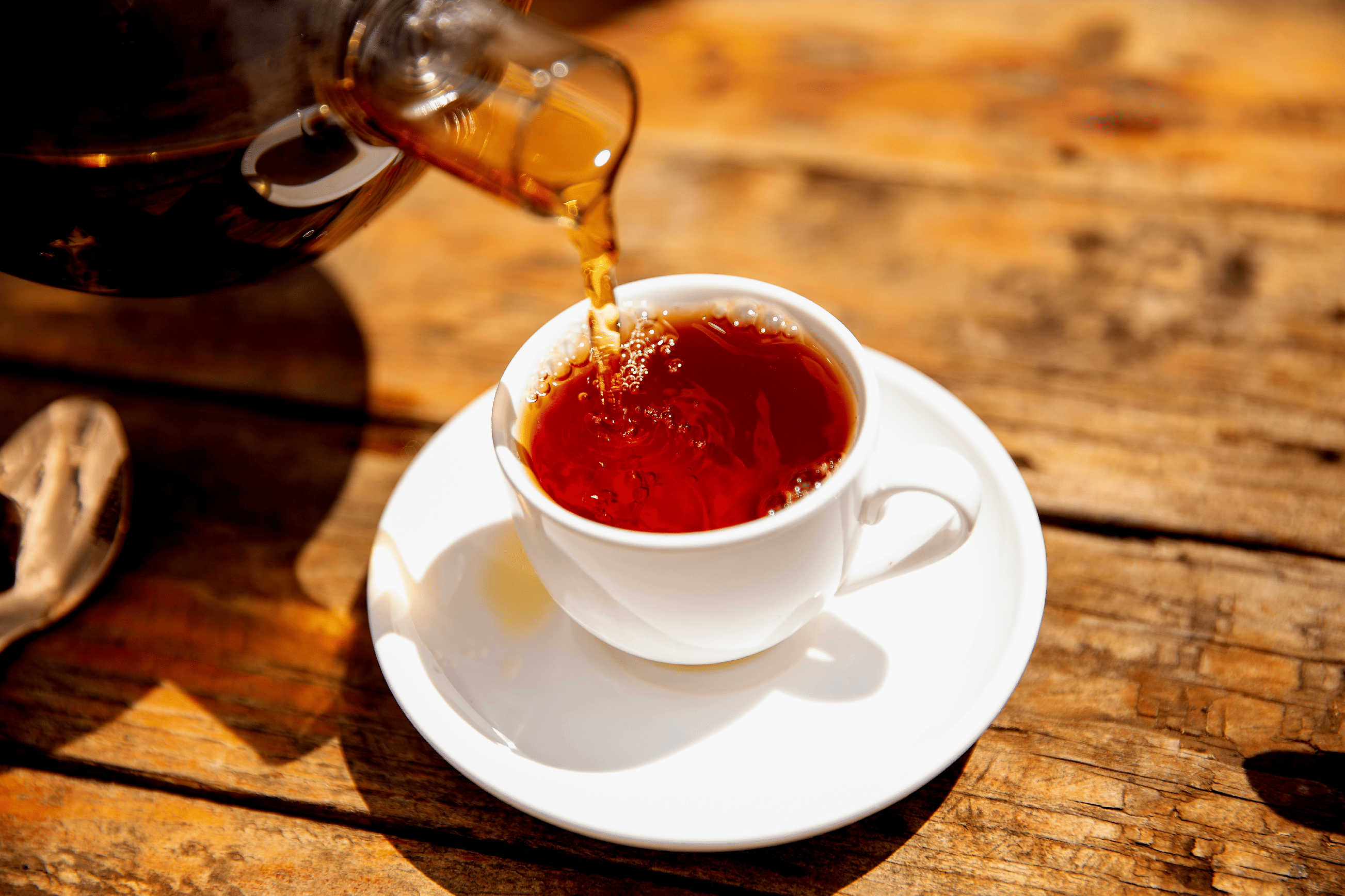 Loose black orthodox tea leaves in a tea setting